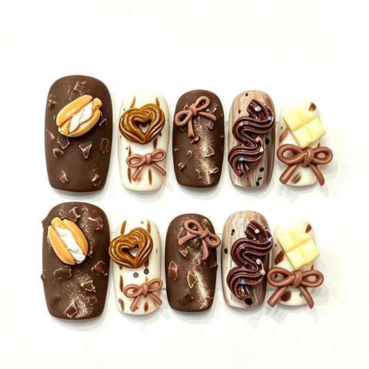 Chocolate and cream press-on nails with sculpted bows and truffle swirls