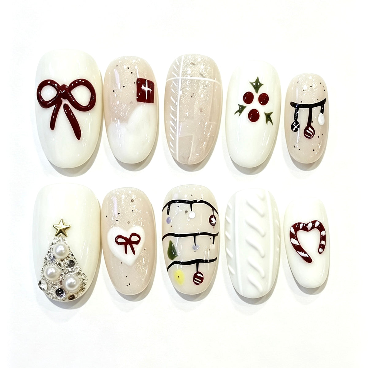 Ivory winter press-on nails with burgundy bows, holly, cable-knit texture and Christmas details